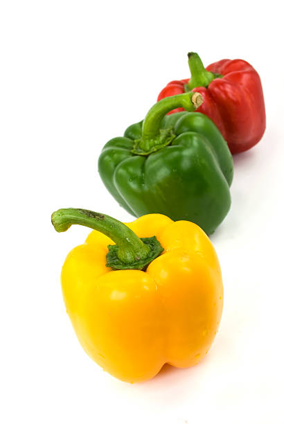 istock Red, green and yellow bell peppers isolated on white 147008937