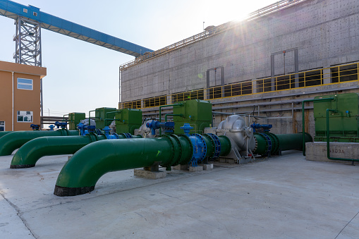 Pipeline and cement building wall of chemical plant under construction