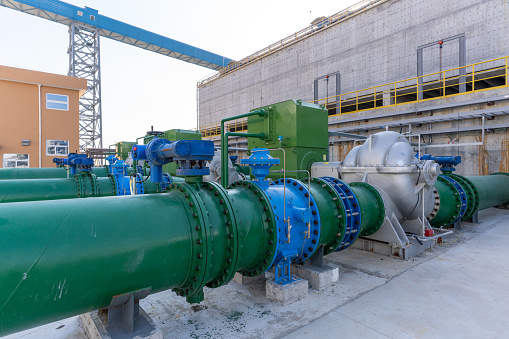 Pipeline and cement building wall of chemical plant under construction