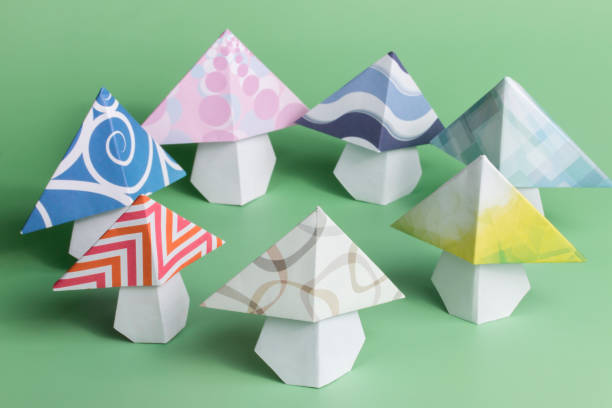 istock Origami mushroom folded paper art on green background 1470094951
