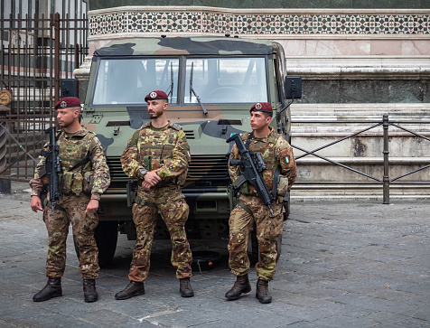 Florence, Italy - June 03, 2022: Carabinieri officers stand next to a police vehicles by the Duomo Cathedral or Cattedrale di Santa Maria del Fiore