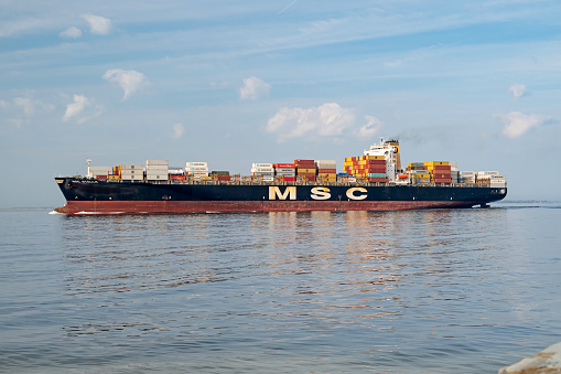 Charleston, SC, USA - February 27, 2023: Stella, a 304-meter container ship owned by Mediterranean Shipping Company and flagged to Panama, sails out of Charleston Harbor.