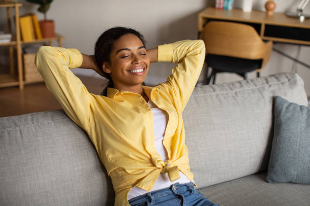 istock Cheerful Black Millennial Lady Resting Sitting On Couch At Home 1470095624