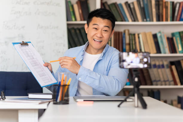 istock Korean Male Teacher Having Virtual Lecture Talking To Cellphone Indoor 1470095703