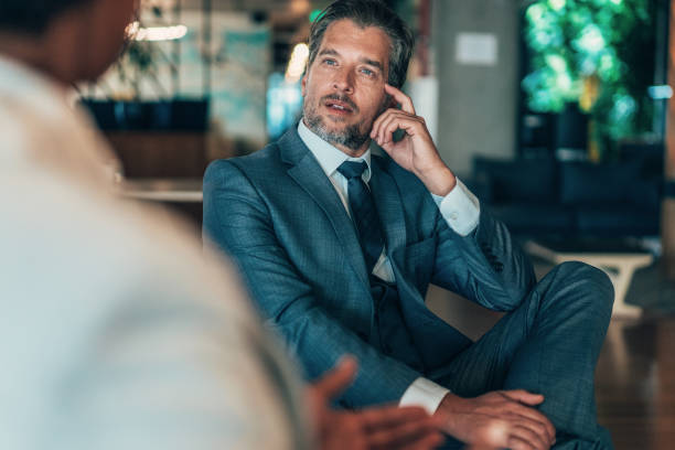 businessman talking to a colleague - ceo financial advisor businessman serious imagens e fotografias de stock