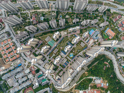 Top view of real estate buildings and green space in modern city