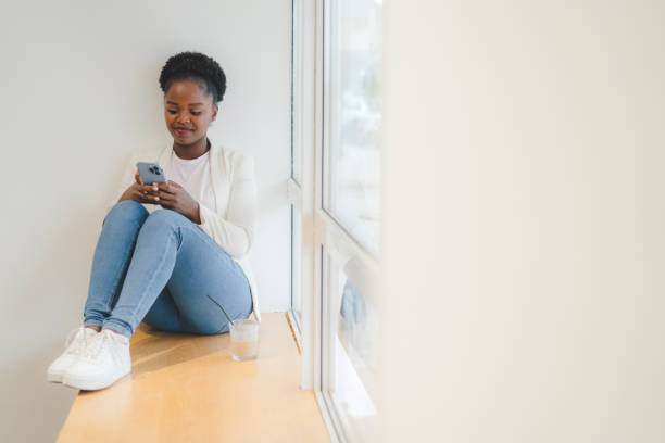 istock Young pretty woman using smartphone, touch screen while having breakfast in the cafe. Woman surfing internet. Internet technology. 1470097222