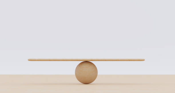 Wooden spheres balancing on seesaw. Concept of harmony and balance in life and work stock photo