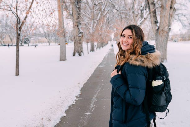 istock Cheerful University Student Standing Looking Over Her Shoulder at Camera on Campus on a Snowy Day in Colorado 1470097701