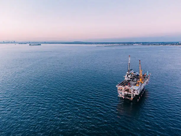 Photo of An Elevated View of an Offshore Oil Drilling Rig at Dusk near Huntington Beach with Copy Space