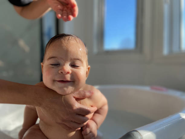 Baby in bathtub taking a bath