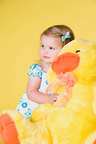 istock Little girl with duck easter portrait 147010533