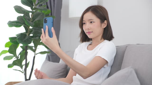 Young asian woman holding smart phone as biometric verification and face detection, Innovations and technology, people and technology lifestyle