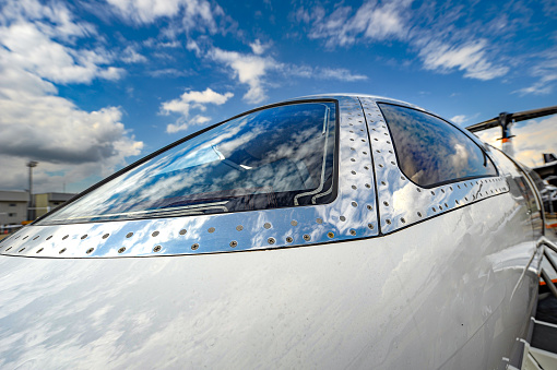 Symmetrical front view of Cessna 172 Skyhawk 2 airplane on an asphalt runway.