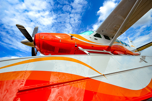 Vintage airplane propeller with radial engine on blue sky background