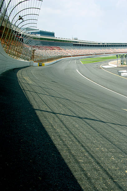 turn 1 A stock car race track shot looking into turn one from the safer barrier (wall). stock car photos stock pictures, royalty-free photos & images