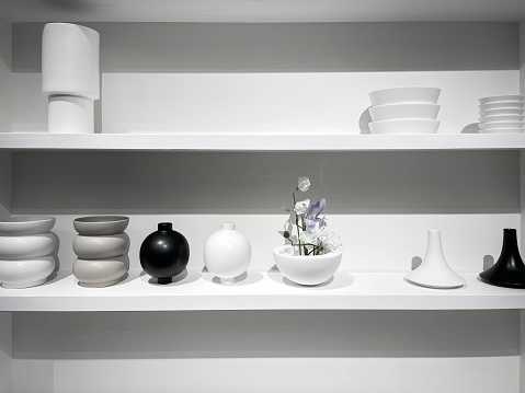 A neat array of ceramic utensils on a clean white shelf