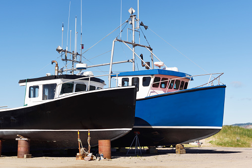 Two dry dock fishing boats on a sunny day