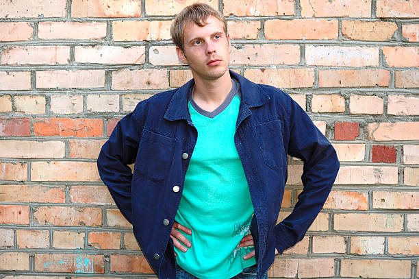 istock Young stylish man stand near brick wall. 147011437