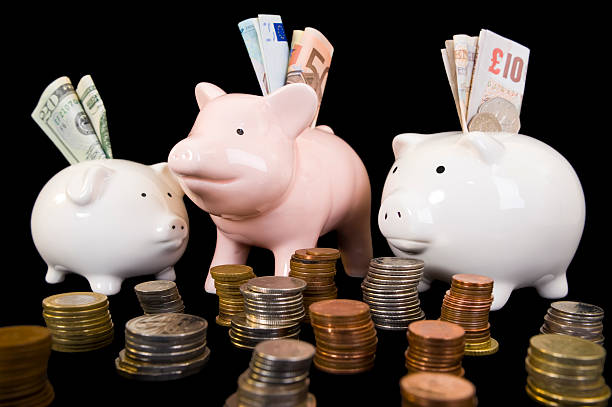 Piggybanks with various currency stock photo