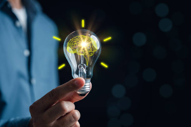 istock Hand man holding illuminated lightbulb, idea, innovation and inspiration with glowing virtual brain, smart intelligent creativity with bulbs, Motivation and innovation concept. 1470115326