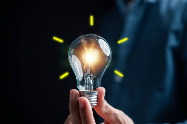 istock Hand man holding illuminated lightbulb, idea, innovation and inspiration with glowing virtual brain, smart intelligent creativity with bulbs, Motivation and innovation concept. 1470115327