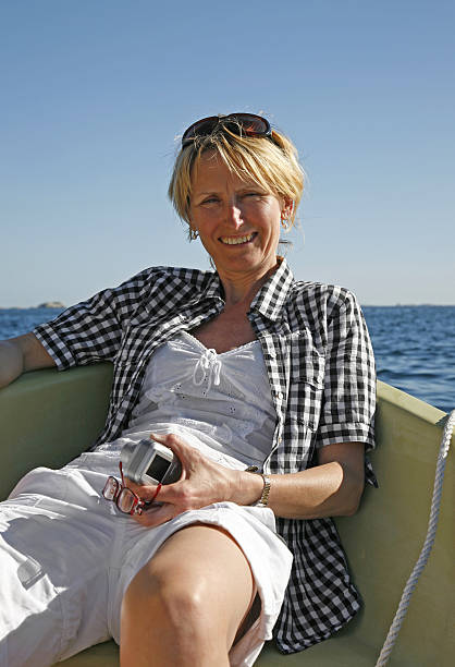 Mature Woman Sitting in a Boat stock photo