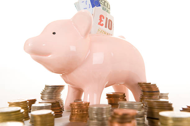 Piggybank with various currency stock photo