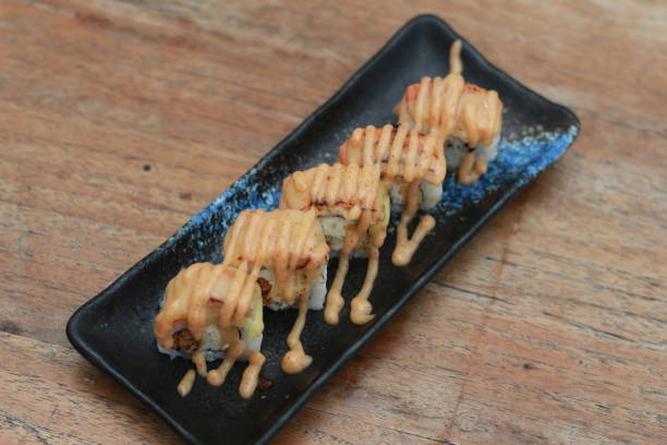 istock Japanese food called Salmon Mozza Sushi. Served warm on a black rectangular plate on the table. 1470119771