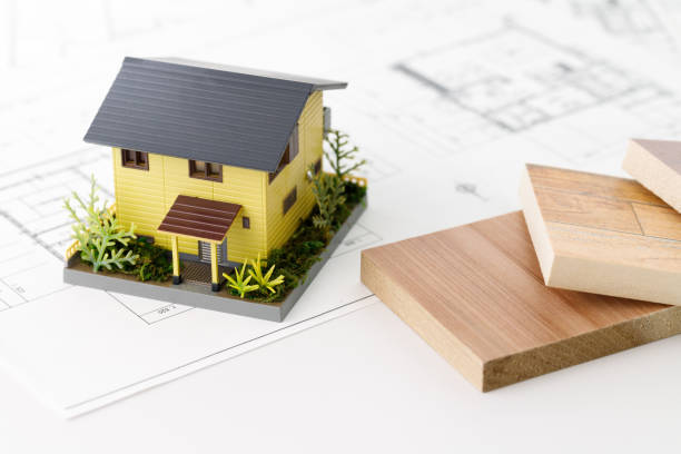 istock Wood samples, house models and floor plans. Real estate planning and consultation image 1470119793