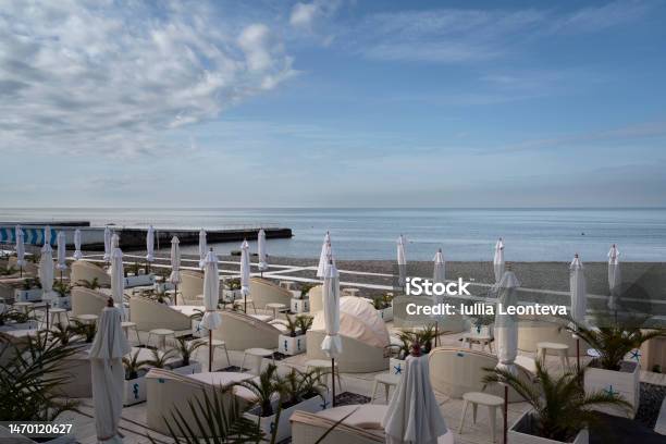 A Deserted Beach On The Coast Of Sochi With Sun Beds And Umbrellas Against The Background Of The Calm Black Sea Adler Krasnodar Territory Russia Stock Photo - Download Image Now