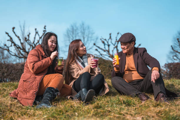 istock Cheerful Asian Family Enjoying An Outdoors Walk 1470120776