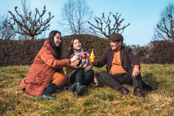 istock Cheerful Asian Family Enjoying An Outdoors Walk 1470120801