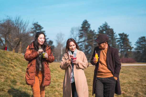 istock Cheerful Asian Family Enjoying An Outdoors Walk 1470120901