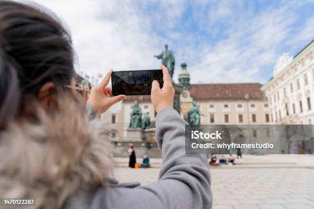 Asian Female Woman Traveller Enjoy Holiday Vacation City Walking Hand Using Smartphone Taking Photo Of Statue Of Francis Ii Vienna City Hall In The Historic City Center Tour In Vienna Austria Stock Photo - Download Image Now