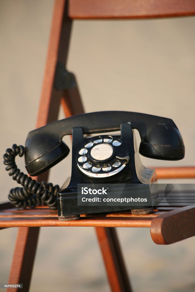 Lost signal - chair on the dune series A rotary phone on a chair in a remote location. Communication Stock Photo