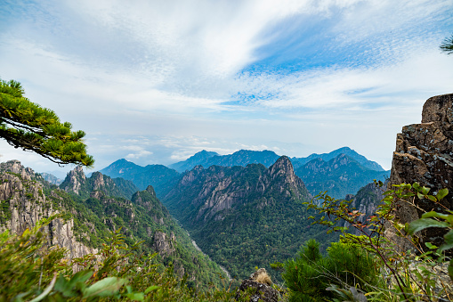 Aerial view of winding dirt road in the mountains and mountain ridge at sunny day