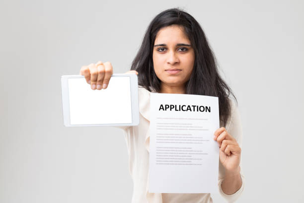 istock Young woman with tablet and form 1470127413