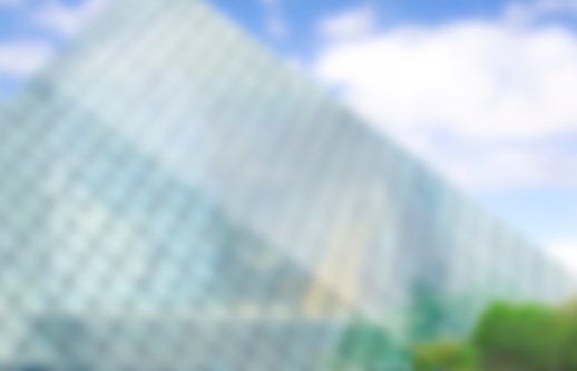 Abstract blur background with the glass pyramid building