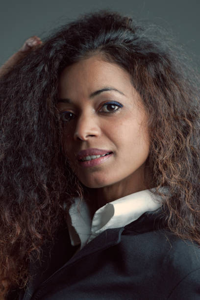 istock Black-skinned woman, wavy hair, elegant, uncertain expression 1470128091