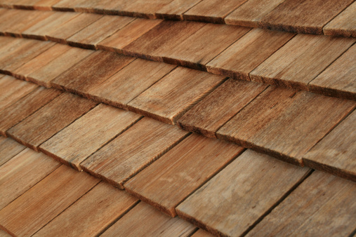 Diagonal detail of brown wood roof shingles