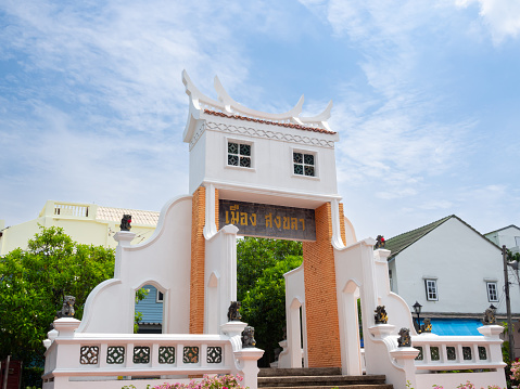 Songkhla Thailand - 8 AUG 2022 : Real ancient Capital Gate at old town in Songkhla City, Thailand. Text on white Capital gate is Mueang Songkhla.