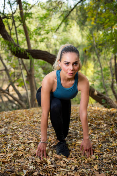 istock Young woman doing exercise in a park 1470130780