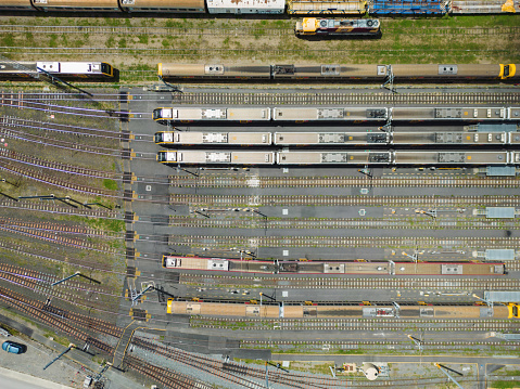 Close up of a suspension unit and wheel on an old railway carriage running on railroad tracks in England.