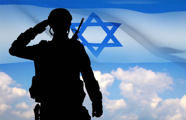 istock Silhouette of a saluting soldier with Israel flag 1470132295