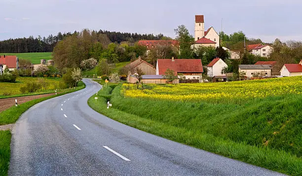 Asphalt road leading to a south german village in Bavaria