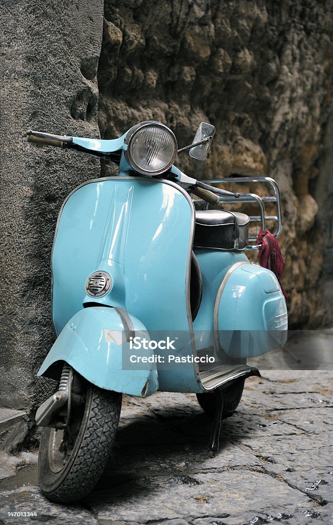 Classic italian scooter Classic italian Vespa scooter parked in an italian cobbled street. Turquoise Colored Stock Photo