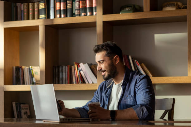 istock Handsome young man working with his laptop. 1470133974