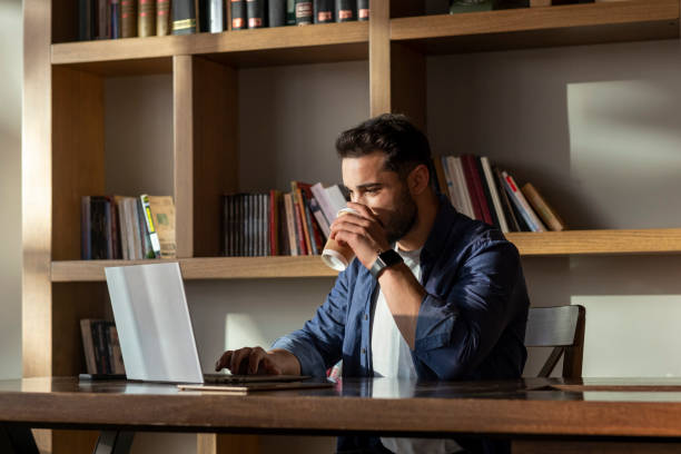 istock Handsome young man working with his laptop. 1470133980