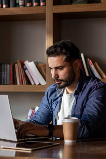 istock Handsome young man working with his laptop. 1470133986